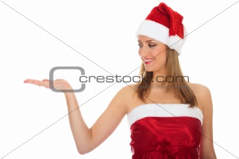 Pretty girl wearing red Christmas hat, holding a hand palm up.