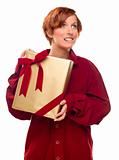 Pretty Red Haired Girl Biting Her Lip Holding Wrapped Gift Isolated on a White Background.