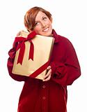 Pretty Red Haired Girl with Wrapped Gift Isolated on a White Background.