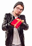 Warmly Dressed Handsome Young Man Handing Wrapped Gift Out Isolated on a White Background.