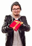 Warmly Dressed Handsome Young Man Handing Wrapped Gift Out Isolated on a White Background.