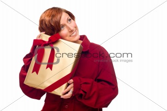 Pretty Red Haired Girl Rests Her Head on a Precious Wrapped Gift Isolated on a White Background.