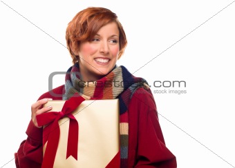 Pretty Red Haired Girl with Scarf Holding Wrapped Gift Looking Off to the Side Isolated on a White Background.