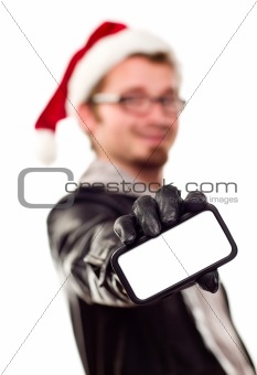 Smiling Young Man with Santa Hat Holding Out Blank Cell Phone Isolated on a White Background.