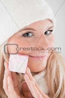 beautiful winter woman in warm casual clothes with little christmas present