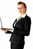 Smiling modern business female holding laptop in hand
