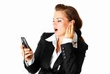 Business woman with earphone listening music on mobile phone
