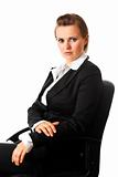 Portrait of serious modern business woman sitting on  office  chair
