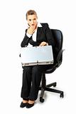 Sitting on chair surprised  modern business woman looking in suitcase
