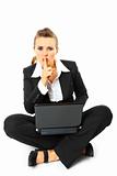  Modern business woman sitting on floor with laptop and holding finger at mouth. shh gesture
