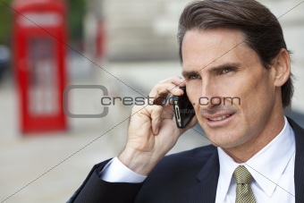 Businessman On Cell Phone In London With Red Telephone Box