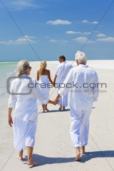 Two Couples Generations of Family Holding Hands on Tropical Beac