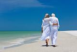 Rear View of Senior Couple Walking Alone on A Tropical Beach
