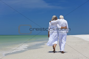 Rear View of Senior Couple Walking Alone on A Tropical Beach