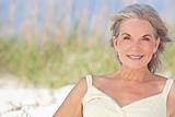 Attractive Elegant Senior Woman Sitting At A Beach