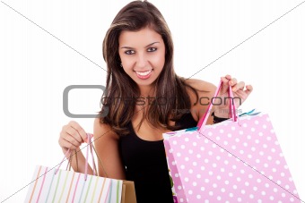 Happy girl with shopping bags, isolated on a white background. Studio shot.