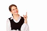 Young happy businesswoman points with finger on copy space