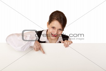Young happy woman points with finger on blank billboard