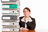 business woman thinks about solving problem with folder stack