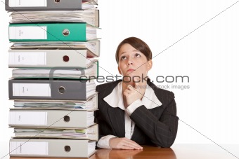business woman thinks about solving problem with folder stack