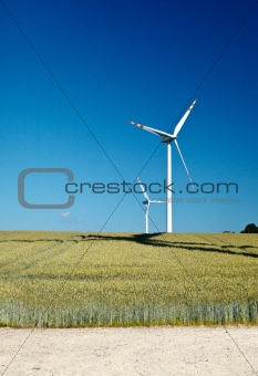 field and two wind turbines
