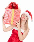 Cheerful santa helper girl with big gift box on her shoulder