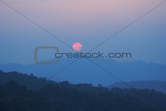 sunset and blue sky above the hill