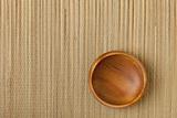 empty wooden bowl on mat