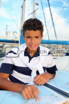 boy teen sailor sitting on marina boat chart map
