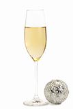 glass of champagne with a metal christmas ball