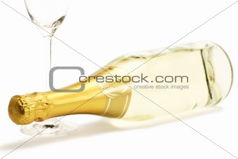 lying champagne bottle with a empty champagne glass