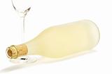 lying dull prosecco bottle with a empty champagne glass