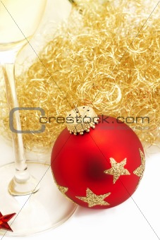 red christmas ball from top with angels hair and a champagne glass