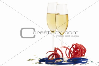 two champagne glasses with blow-outs and confetti