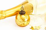 a golden vintage christmas ball with bottom of a champagne glass and a champagne bottle