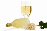 creamy rose in front of two champagne glasses and a prosecco bottle