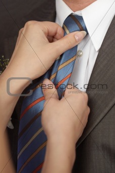 Woman ties man to tie