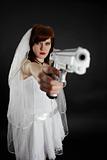 Serious bride take aim with a pistol