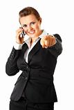  Smiling modern business woman talking on mobile phone and  pointing finger at you
