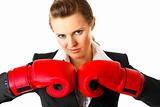 Confident modern business woman with boxing gloves
