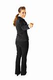 Full length portrait  of friendly modern business woman pointing finger at you
