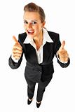  Full length portrait  of pleased modern business woman showing thumbs up gesture

