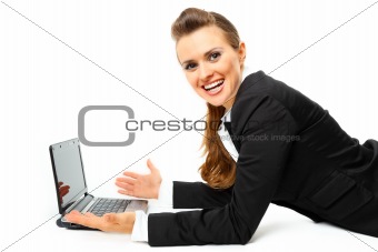 Laying on floor pleased modern business woman using  laptops
