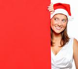 Woman in Santa's hat holding a blank board