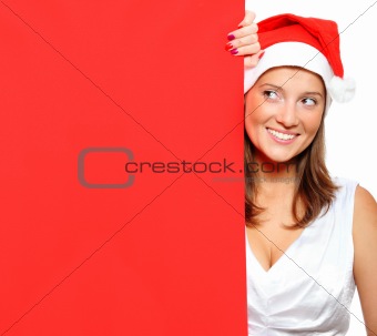 Woman in Santa's hat holding a blank board