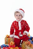 Boy in christmas clothes with presents