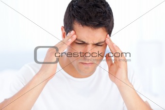 Portrait of a sick man having a migraine