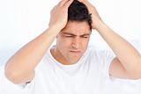 Man suffering from a migraine on waking