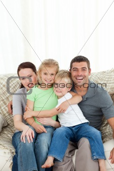 Joyful family sitting on the sofa