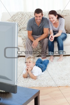 Family watching television together at home